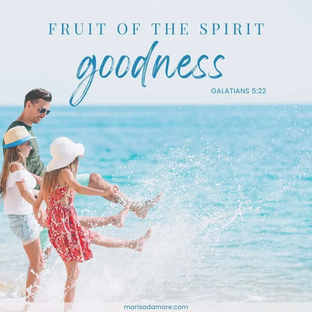 Dad with his two young daughters splashing water in the ocean with image text 'Fruit of the spirit goodness - Galatians 5:22'