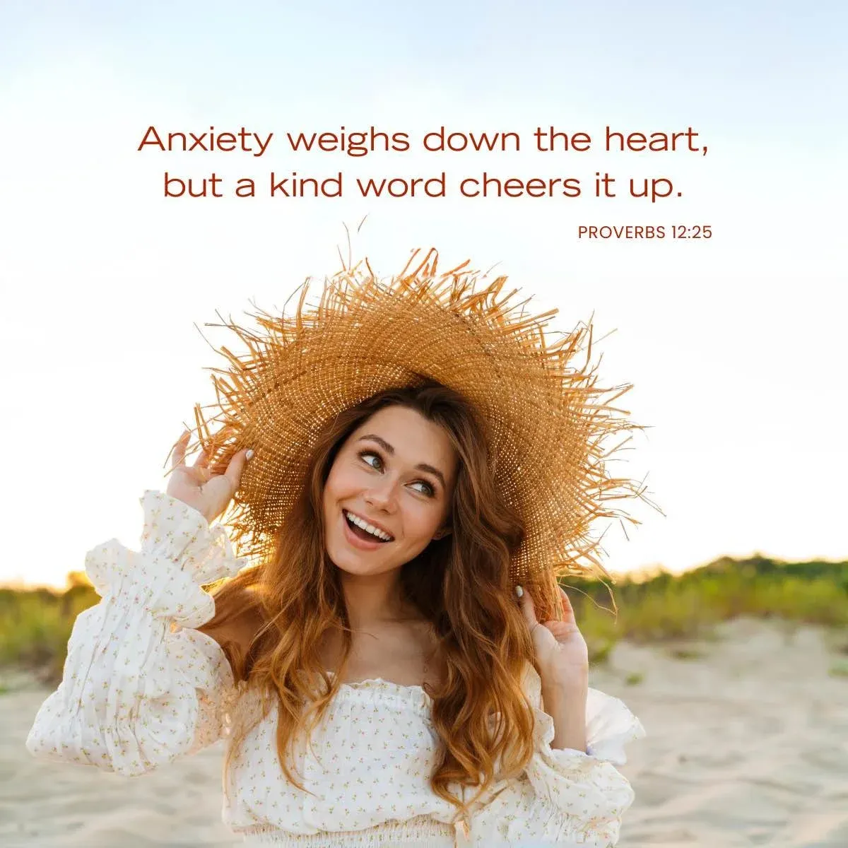 smiling young woman holding straw hat on head